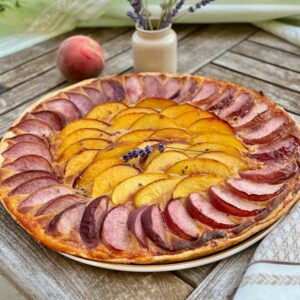 fresh peach and nectarine slices arranged on puff pastry and an almond paste