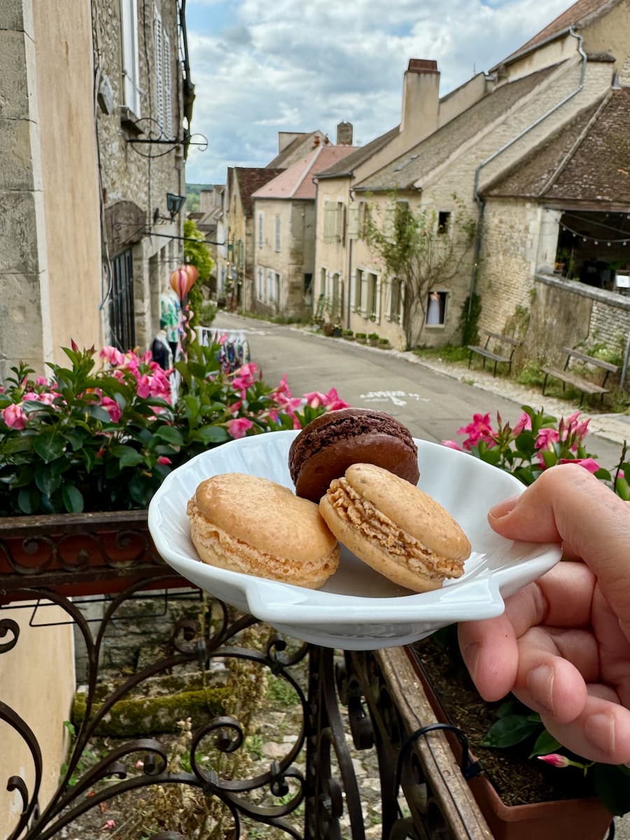 French hilltop village with a scallop plate of Parisian macarons