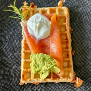 savoury waffles topped with smoked salmon, smashed avocado and soured cream