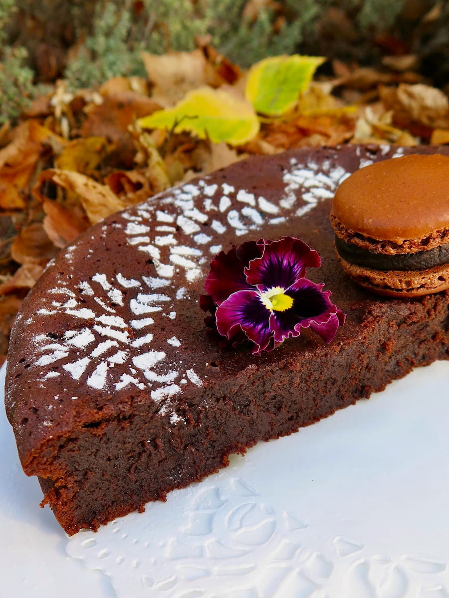 half of a French fondant au chocolat, a dense, one-layered chocolate cake, showing a fudgy interior