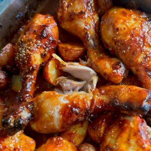 tender sticky baked chicken drumsticks coated in a homemade bbq sauce with sesame seeds