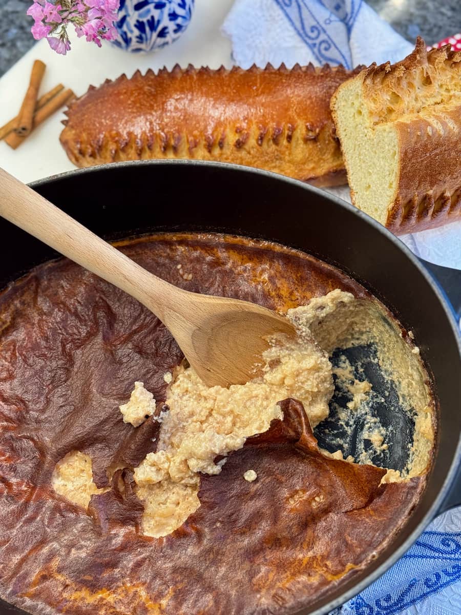 creamy rice pudding out of the oven with a dark skin on it, served with the  traditional French Fallue brioche