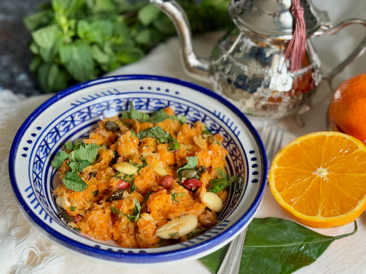 Moroccan handpainted dish with a healthy salad of carrots, nuts, mint and orange
