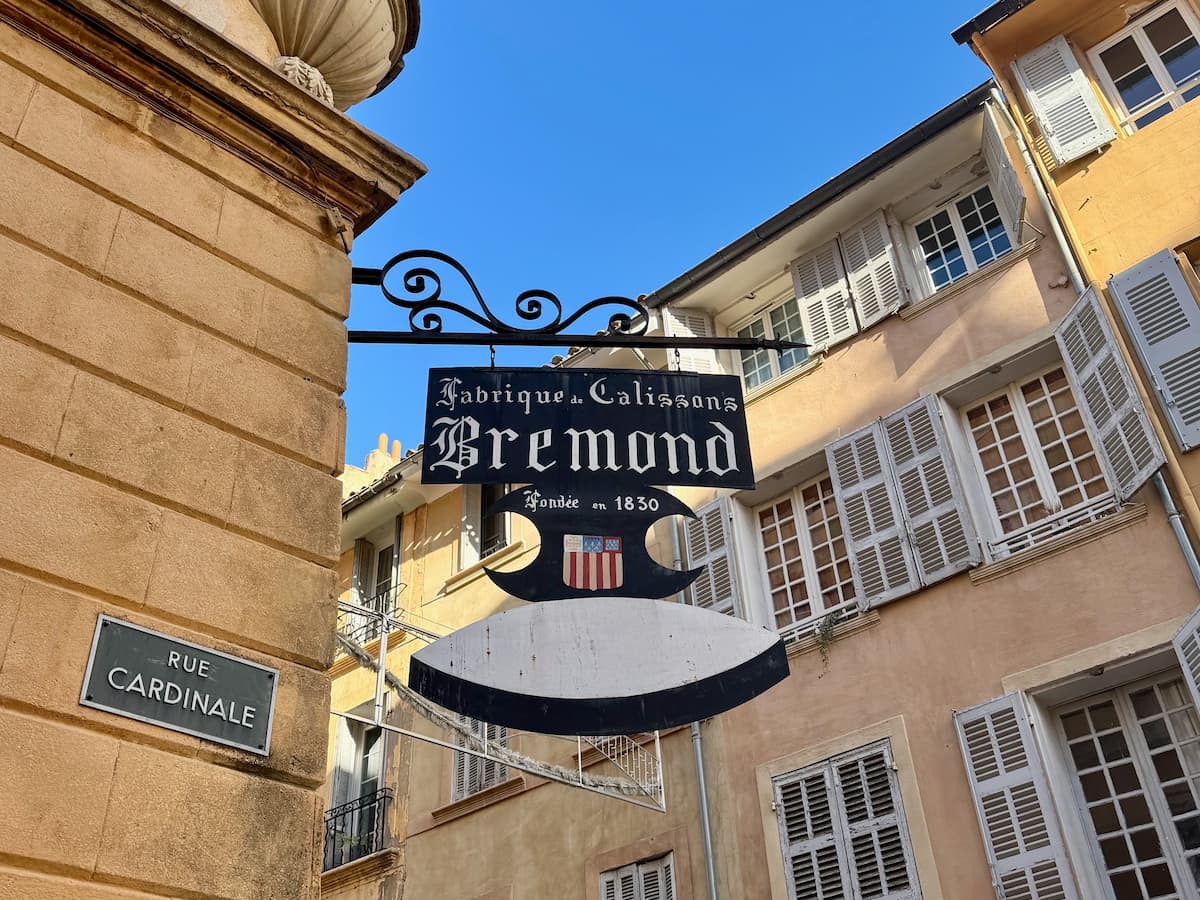 decorative shop sign on a building with a diamond shape calisson sweet saying Bremond