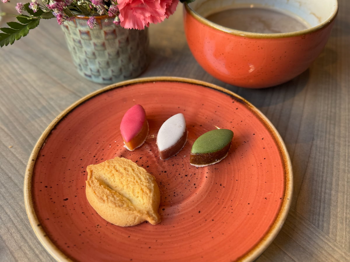 plate of a navette biscuit and Calissons from Aix-en-Provence with morning coffee