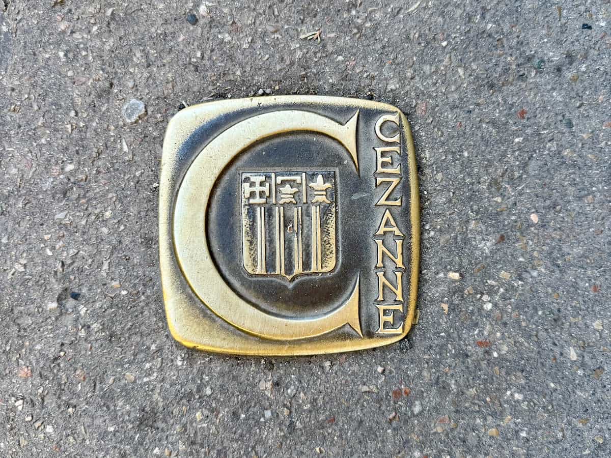Bronze tile in the ground with a large C for Cezanne and the crest of Aix-en-Provence