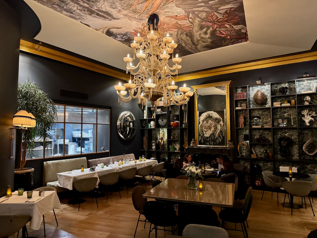 inside the famous Coupole restaurant in Aix with large chandelier and long tables