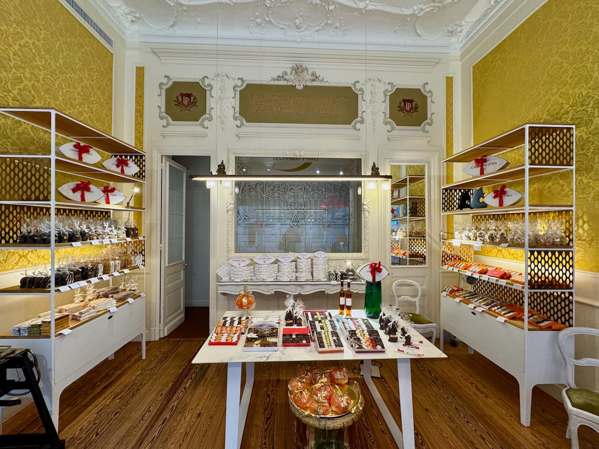 inside an elegant confectionary shop in Aix with shelves of almond sweets