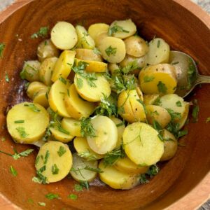 sliced potatoes tossed in white wine, vinaigrette and fresh chopped herbs