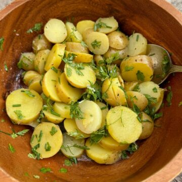 sliced potatoes tossed in white wine, vinaigrette and fresh chopped herbs