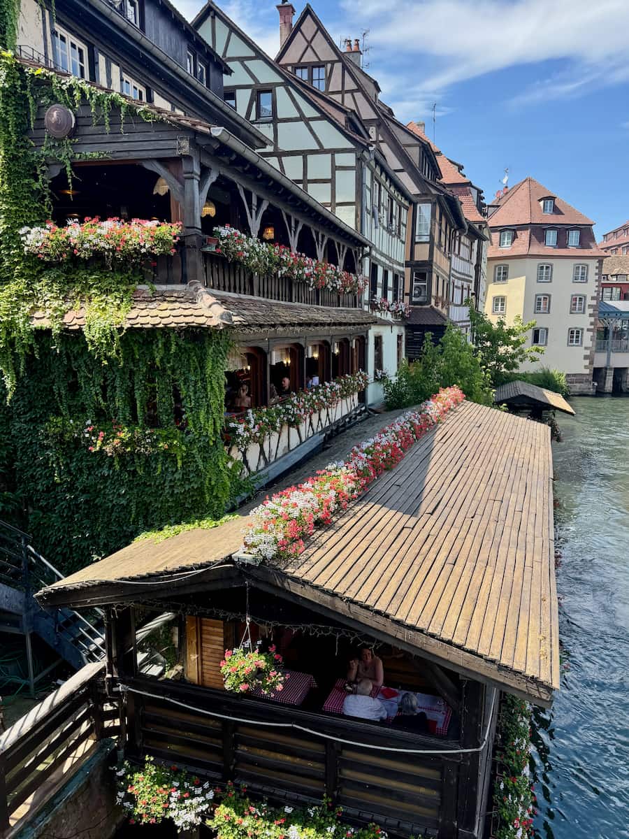 riverside restaurant on the Ill river in Petite France in Strasbourg with flowers