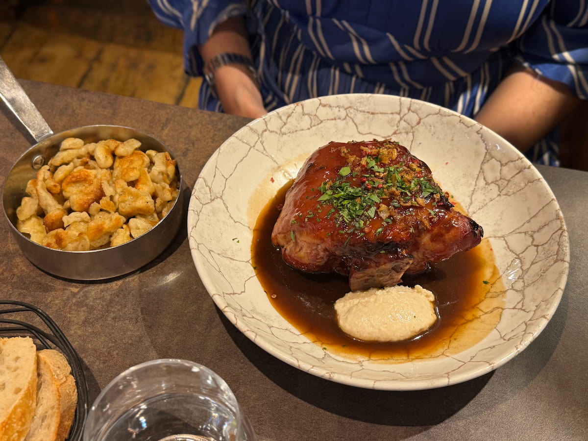 a large ham hock braised in beer and honey served with horseradish sauce and a side dish of spaetzle pasta fried in a little pan